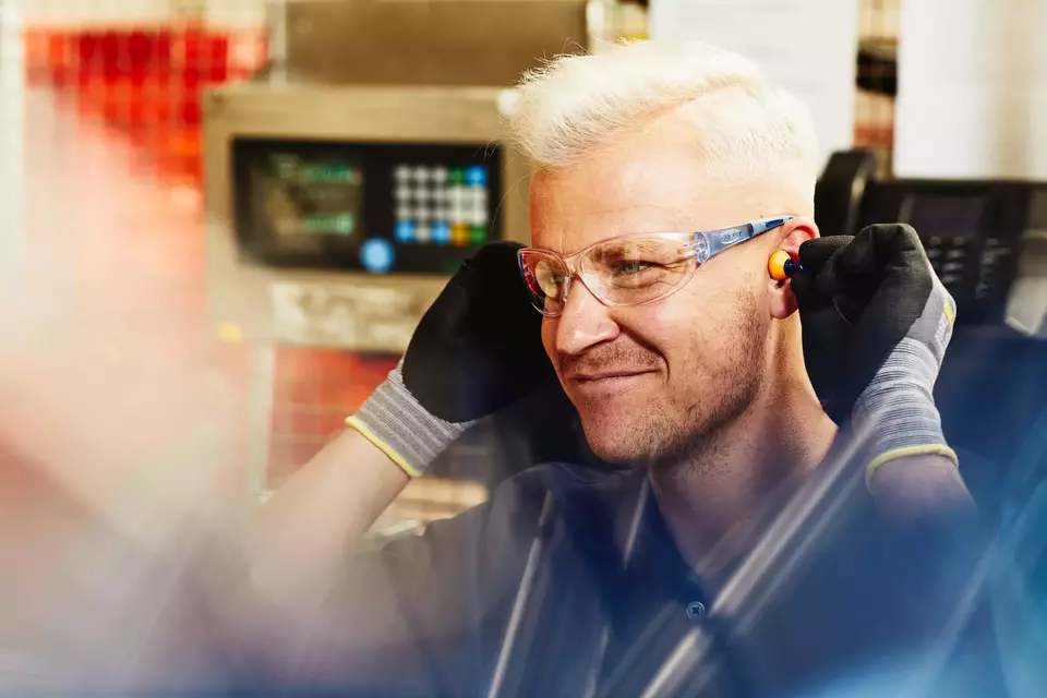 focused male looking away wearing protective gear at work