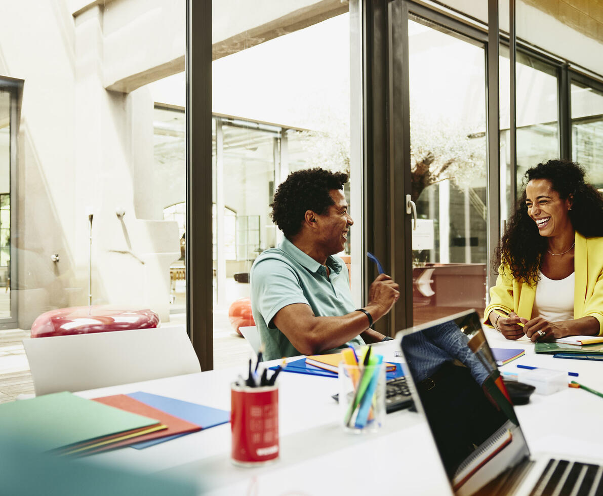 male and female having a laugh during a meeting in a meeting room.
 male and female having a laugh during a meeting in a meeting room.